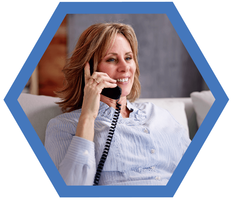 Woman-phone-hexagon-blue Woman talking on home phone